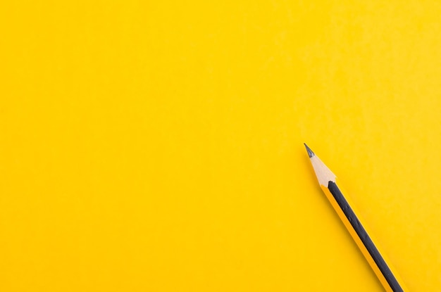 High angle view of pencils on yellow background