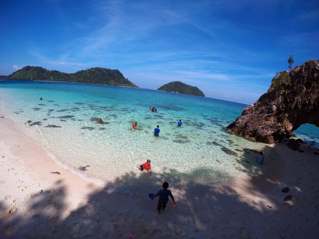 High angle view of people on beach against blue sky