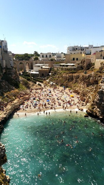 High angle view of people on beach against clear sky