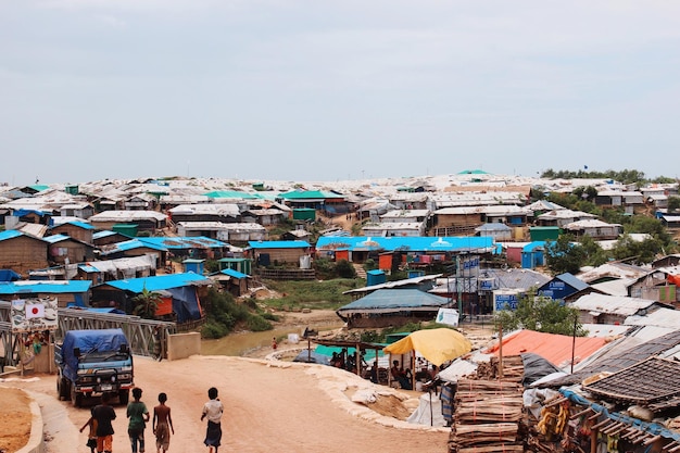high angle view of people on beach by buildings against sky