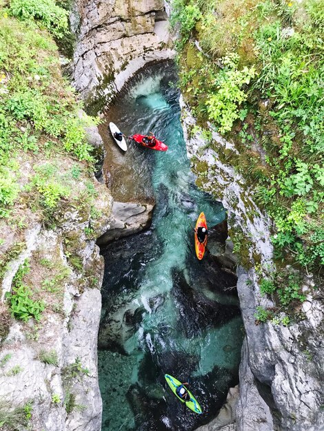 High angle view of people kayaking on river amidst rock formation