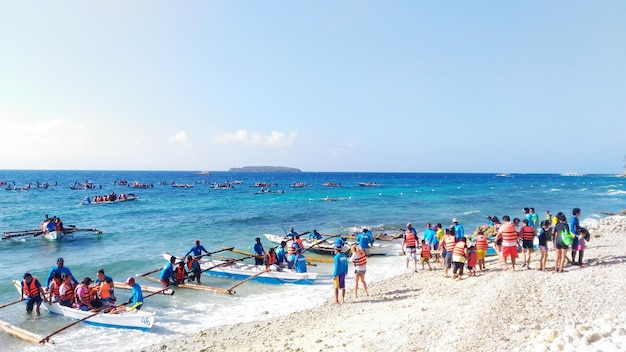 High angle view of people and outrigger boats at beach