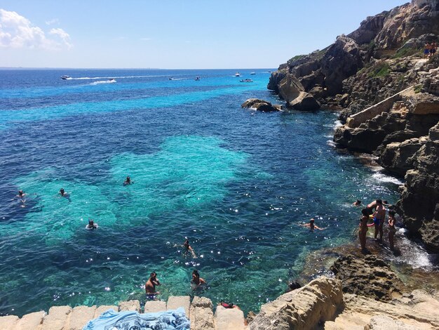 High angle view of people in sea against sky