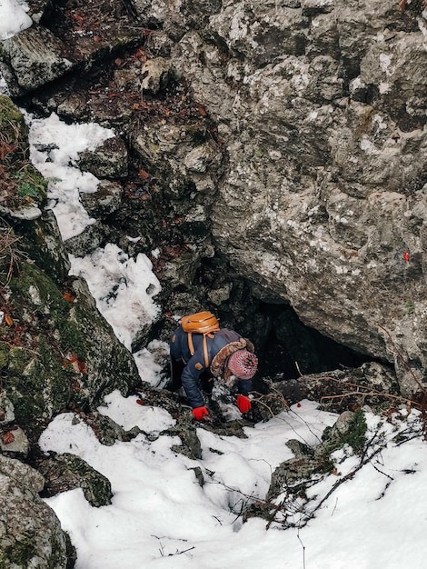 Photo high angle view of people on snow covered rock