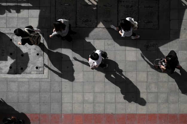high angle view of people standing on footpath