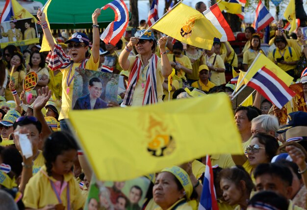 High angle view of people with picture frame and thai flags at event