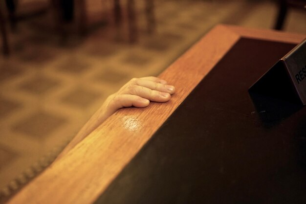 High angle view of person hand on table