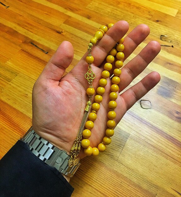 High angle view of person hand on table