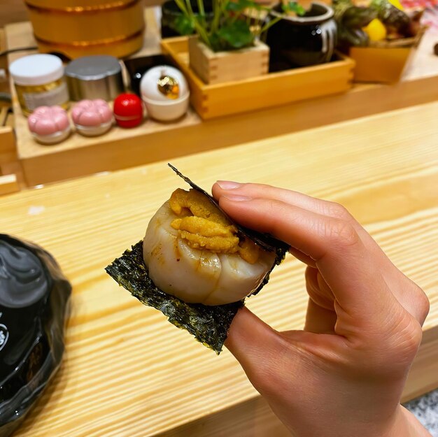 High angle view of person holding food on table