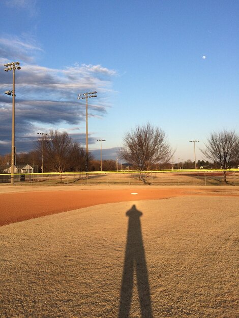 High angle view of person shadow on field against sky