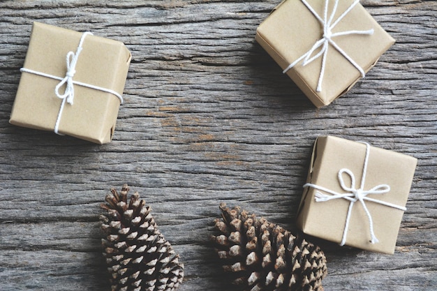 High angle view of pine cones and gift boxes on wooden table