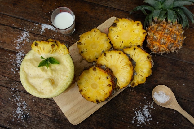 High angle view of pineapple slices on serving board at table