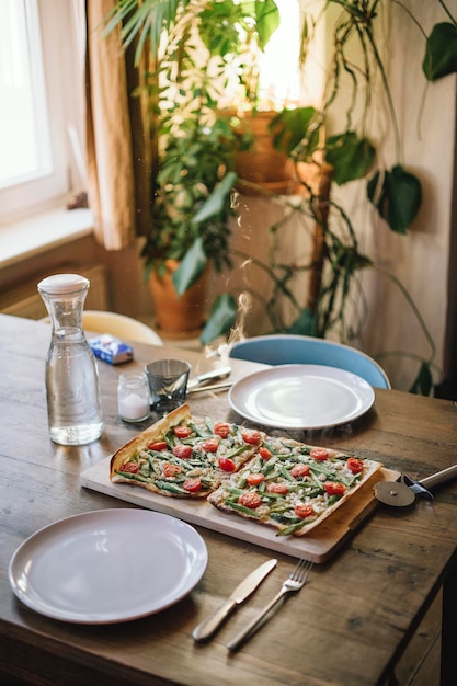 high angle view of pizza served on wooden table at home
