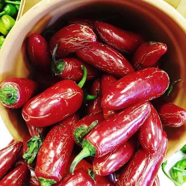 High angle view of red chili peppers in bucket