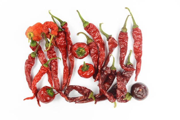 High angle view of red chili peppers on white background