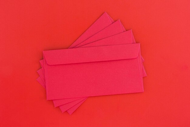 High angle view of red envelopes on colored background