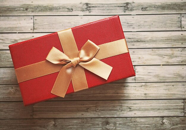 High angle view of red gift box on wooden table