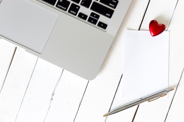 High angle view of red heart shape and laptop on table