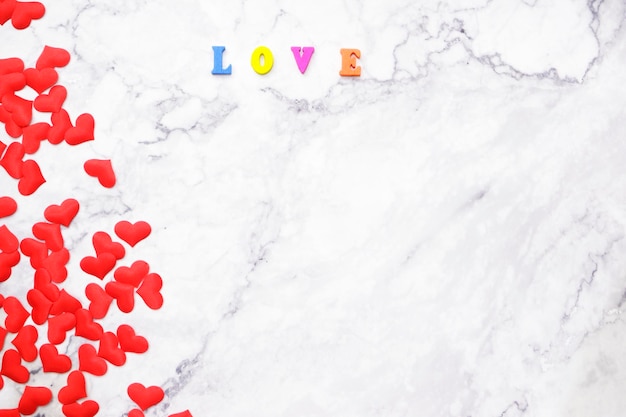 High angle view of red heart shape and love text on table