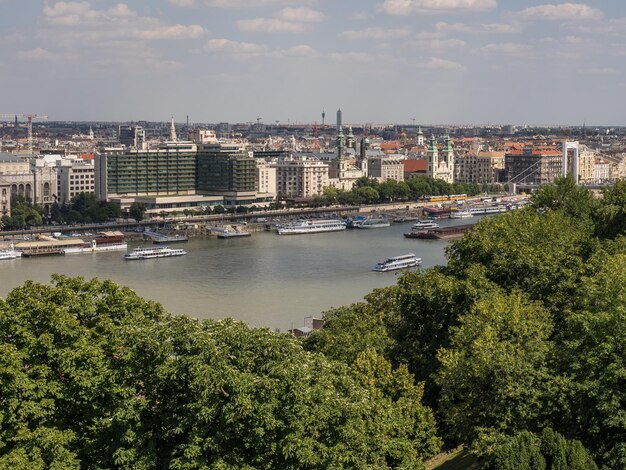 High angle view of river and cityscape against sky