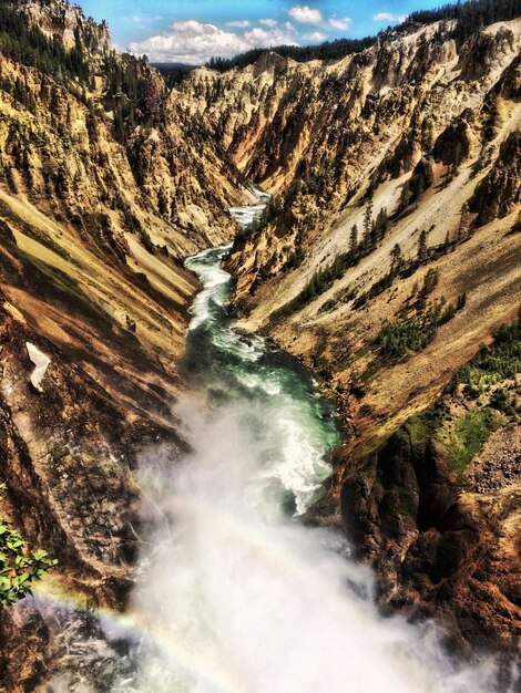 High angle view of river flowing amidst mountains