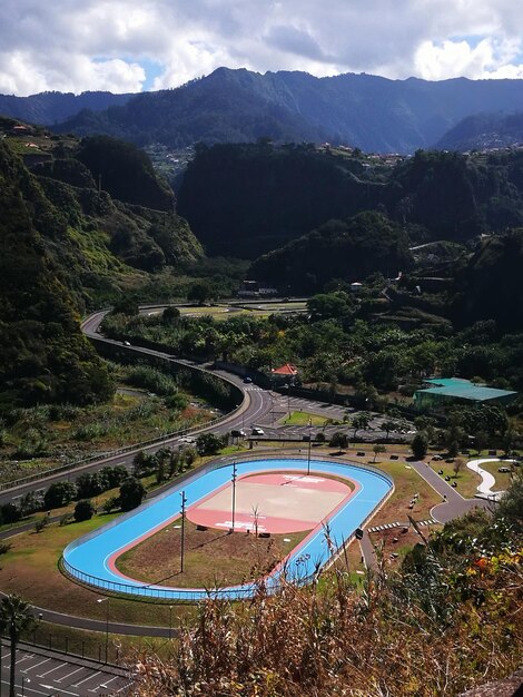 High angle view of road by mountains against sky