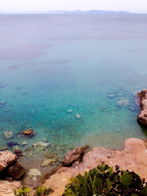 High angle view of rocks in sea against sky