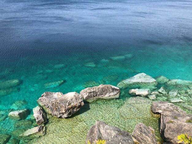 High angle view of rocks on sea shore