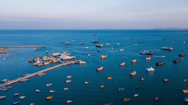 High angle view of sailboats moored in sea against sky