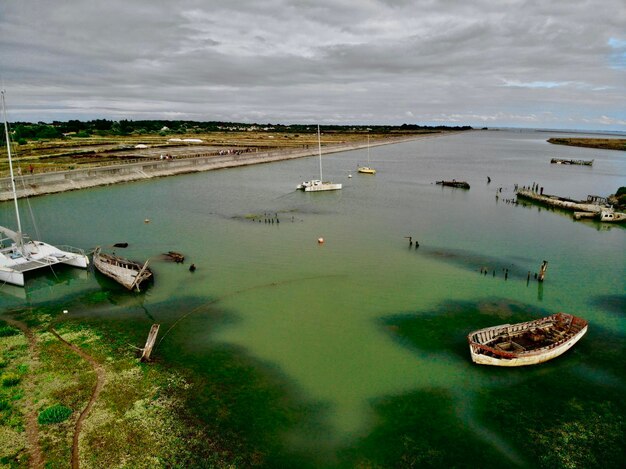 High angle view of sailboats moored on sea against sky