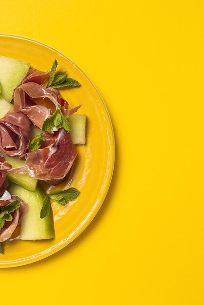 High angle view of salad in plate on yellow background