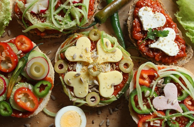 High angle view of sandwiches and burgers served on wooden board