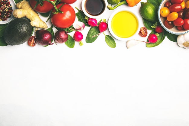 High angle view of sauces in plates by vegetables against white background