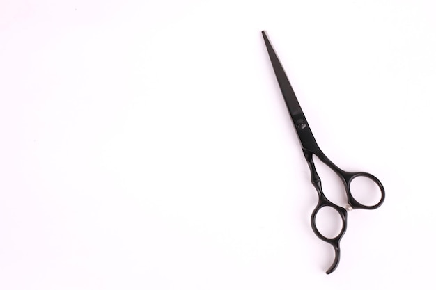 High angle view of scissors against white background