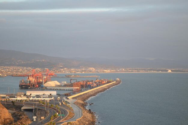 High angle view of sea and city against sky