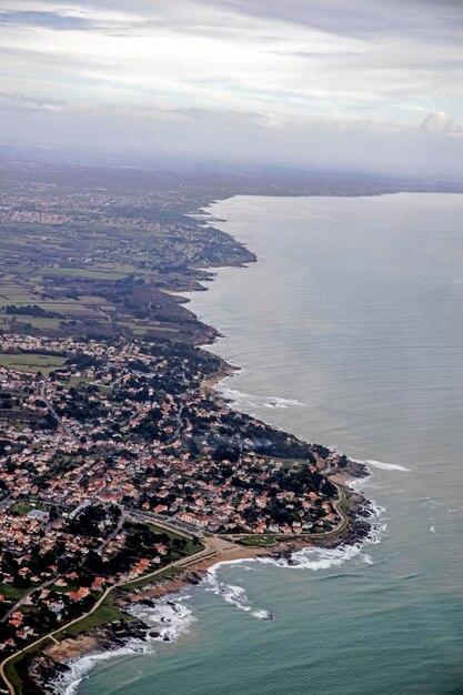 High angle view of sea and cityscape against sky