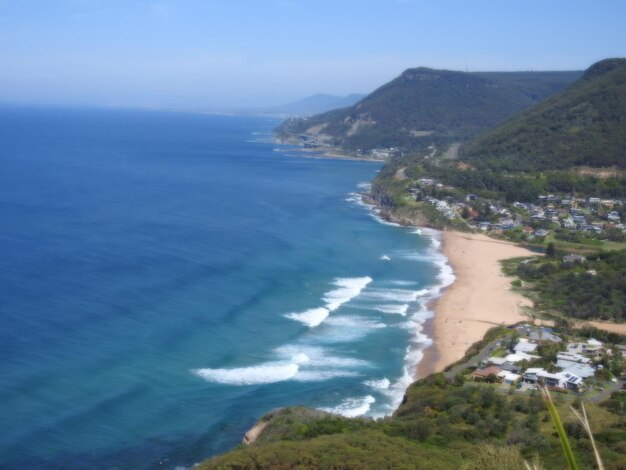 High angle view of sea and mountains against sky