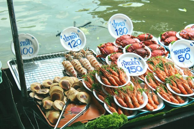 Photo high angle view of seafood for sale in market against lake