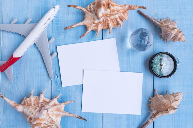 High angle view of seashells and personal accessories on blue table