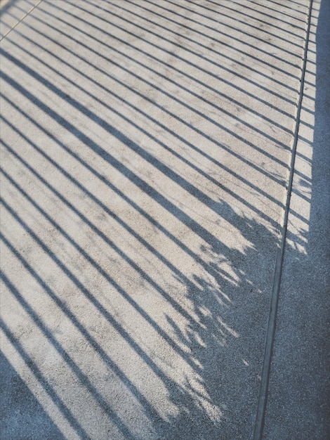 High angle view of shadow on footpath