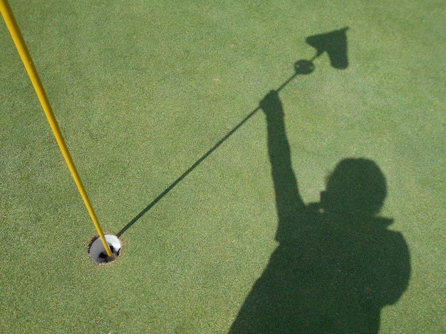 high angle view of shadow of man on golf course