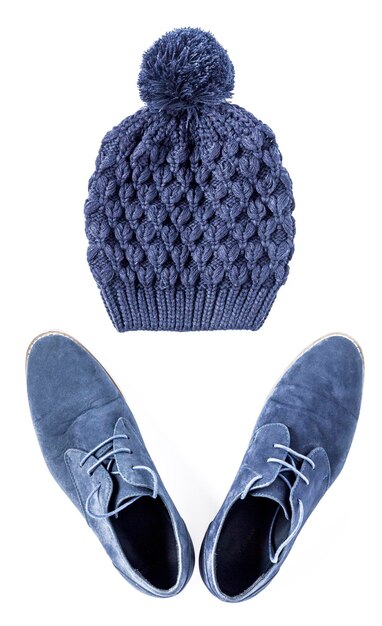 High angle view of shoes and knit hat against white background