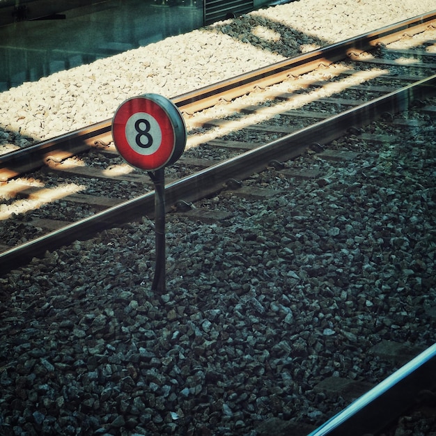 Photo high angle view of sign amidst tracks