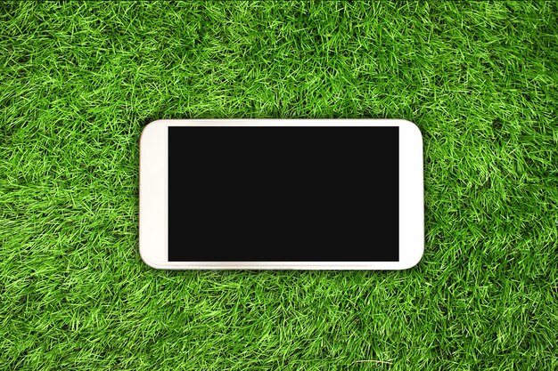 Photo high angle view of smart phone on field