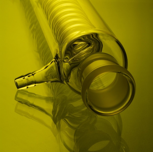 High angle view of spiral condenser on yellow background