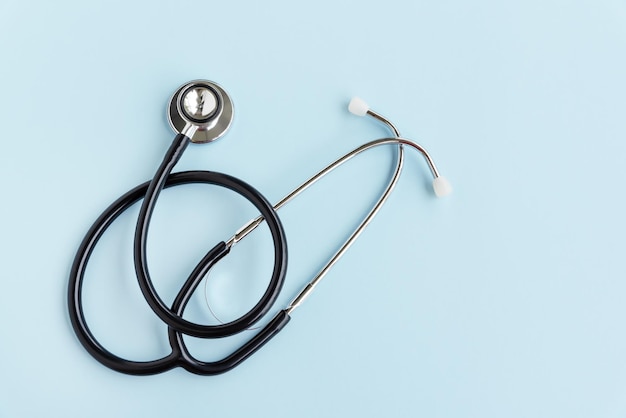 High angle view of stethoscope against blue background