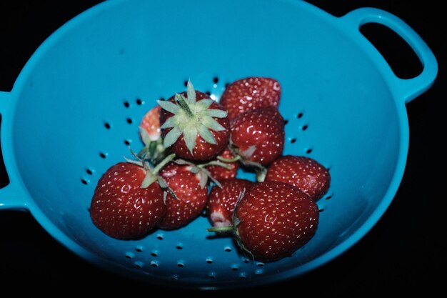 High angle view of strawberries in bowl on table