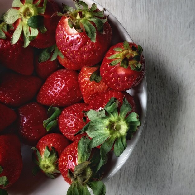 High angle view of strawberries in bowl on table