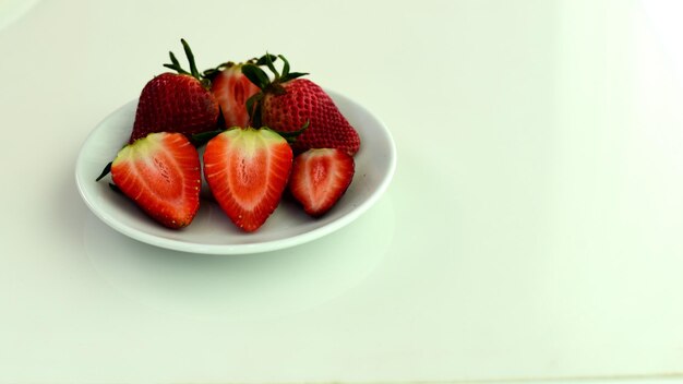 High angle view of strawberries in plate on table