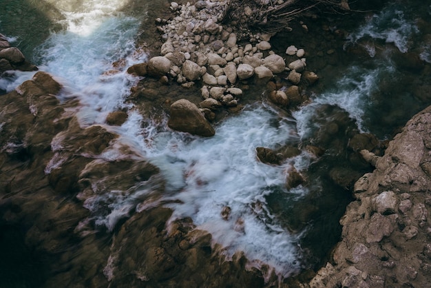 High angle view of stream flowing through rocks